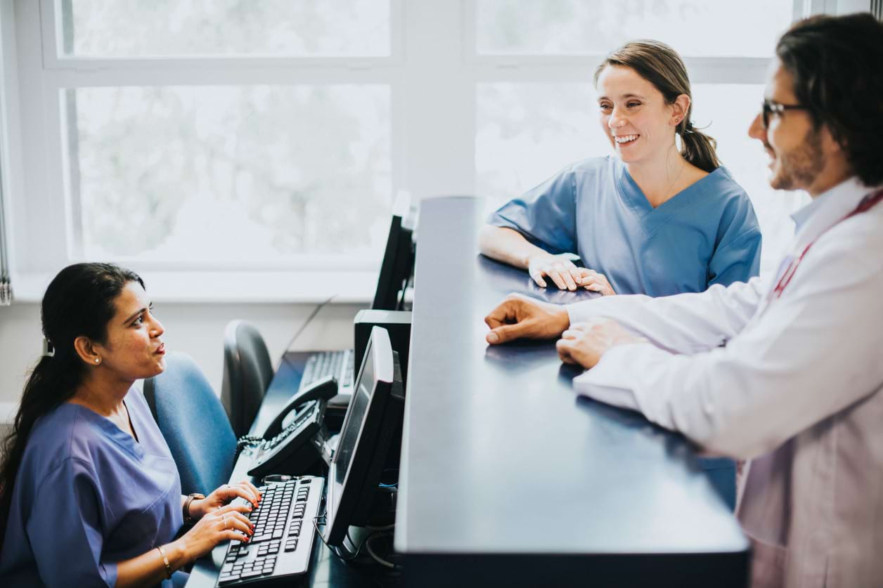 Medical administrator apprenticeship supporting healthcare teams and patient services Healthcare administrators managing patient reception and records in a medical environment
