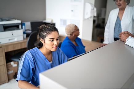 Regular progress reviews ensure apprentice success Employer reviewing apprentice progress and development in healthcare administration