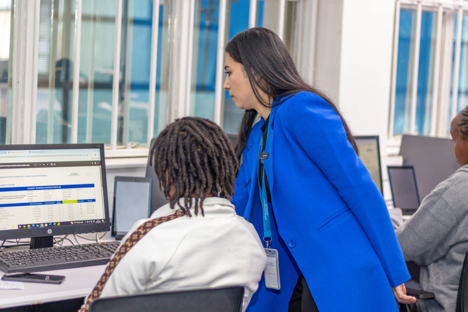 Pitman Training instructor supporting a student studying a digital marketing course at a training centre