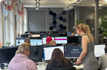 Student studying at a Pitman Training centre with on-site learning coach support