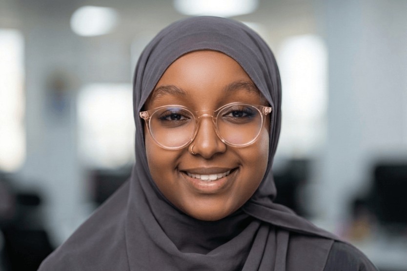 Aziza Hussein Fakhrudin - Legal Secretary Diploma Success Story Aziza Hussein Fakhrudin, Pitman Training Kenya Legal Secretary Diploma graduate, smiling in glasses in an office