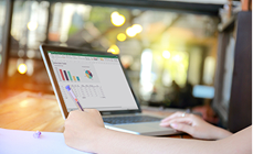 Person analysing data charts and graphs on a laptop Person analysing data charts and graphs on a laptop