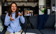 Woman filming social media content on a smartphone tripod Woman filming social media content on a smartphone tripod
